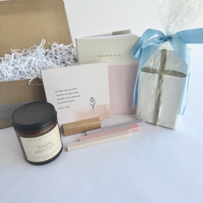 Faith-inspired encouragement gift basket with a cross, candle, and scripture cards